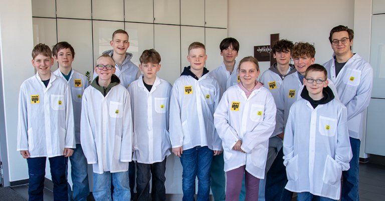 Ein Gruppenbild von zwölf Kindern im ESD-Kittel am Zukunftstag bei straschu